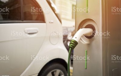 An electric car in charging on the street